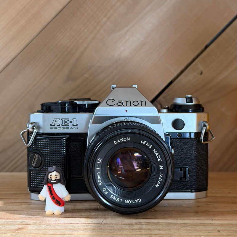 Canon AE-1 Program 35mm SLR Film Camera w/ Canon FD 50mm f/1.8 Lens (4504026) (Silver Body)