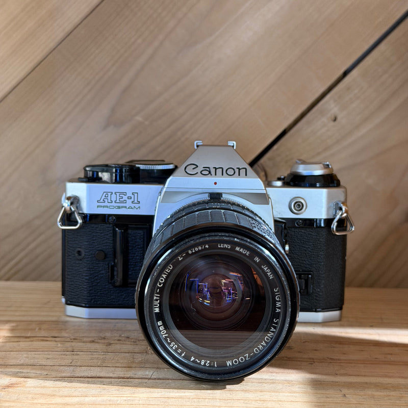 Canon AE-1 Program 35mm SLR Film Camera w/ Sigma Zoom 35–70mm f/2.8–4 Lens (1703074)